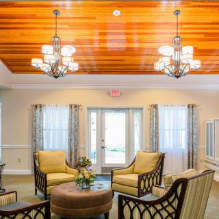 A cozy living room with elegant chandeliers and comfortable seating.