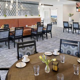 A cozy indoor dining area with neatly arranged tables and chairs.