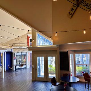 A vibrant and modern interior space featuring stylish furniture and ambient lighting.