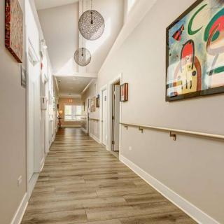 A modern hallway with artistic decor and stylish lighting.