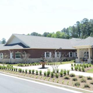 A modern community center surrounded by well-maintained landscaping.