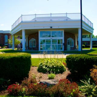 A beautifully landscaped building on a sunny day.