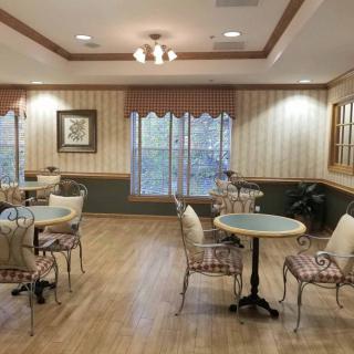 An inviting cafe interior with tables and chairs on a wooden floor.