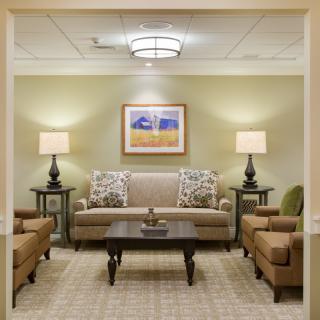 A well-furnished living room with comfortable seating and warm lighting.