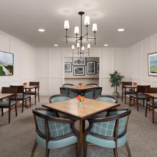 A well-appointed dining room with elegant furniture and a modern chandelier.