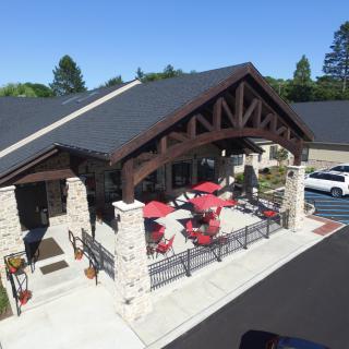 A cozy restaurant with outdoor seating and a modern architectural design.