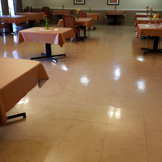 An empty restaurant dining area with arranged tables and chairs.