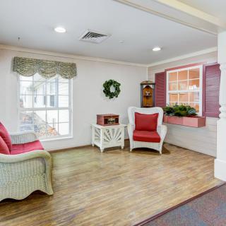 A cozy living room with wicker furniture and decorative accents.