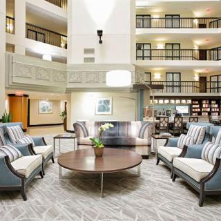 A spacious hotel lobby with modern furniture and elegant decor.