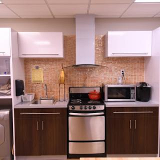 A modern kitchen setup featuring sleek cabinets and essential appliances.