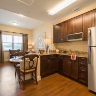 A modern kitchen and dining area with wood flooring and contemporary decor.