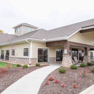 A modern residential building with landscaped grounds and a welcoming pathway.