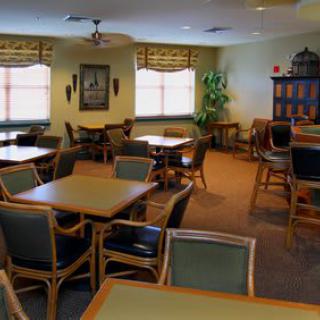 An empty dining room with tables and chairs neatly arranged.