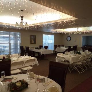 A well-decorated dining area with elegantly arranged tables and chairs, suitable for events.