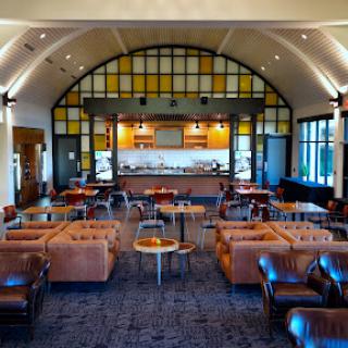A stylish lounge with leather seating and a well-designed bar area.