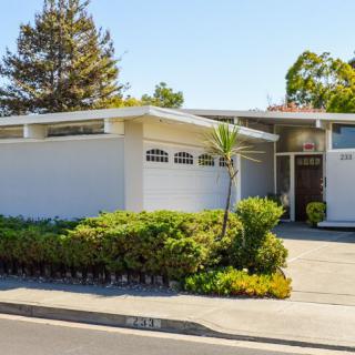 A mid-century modern house with a sleek exterior and well-maintained landscaping.