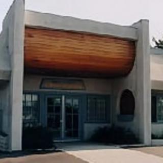 A uniquely designed building entrance with wooden accents.
