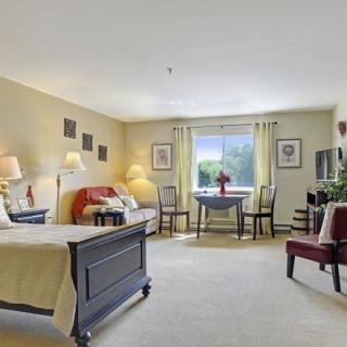A spacious bedroom featuring elegant furniture and abundant natural light.