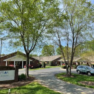 A serene residential area featuring well-maintained buildings and lush trees.