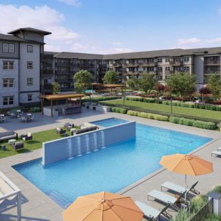 Modern apartment complex with a central swimming pool and outdoor recreation area.