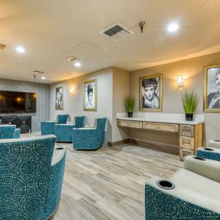 A modern lounge area with comfortable seating, artwork on the walls, and stylish decor.