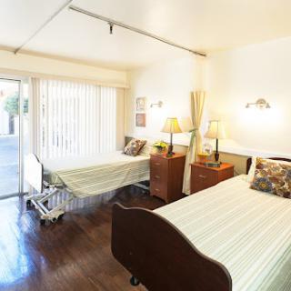 A serene hospital room with two beds, designed for patient comfort and care.