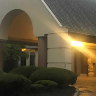 An inviting entrance to a building illuminated by soft evening light.