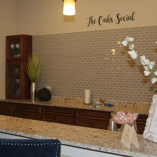 A modern kitchen interior with a decorative backsplash, cabinets, and countertop arrangement.