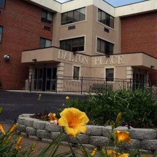 A building with landscaped flowers at its entrance.