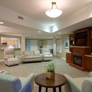A spacious and modern living room featuring comfortable seating and a fireplace.