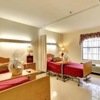 A well-organized hospital room with two beds and medical equipment.