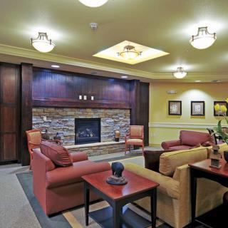 A cozy living room with comfortable seating and a fireplace.