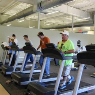 People exercising on treadmills in a gym.