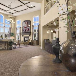 Spacious and elegantly designed lobby with high ceilings, large windows, and decorative elements.