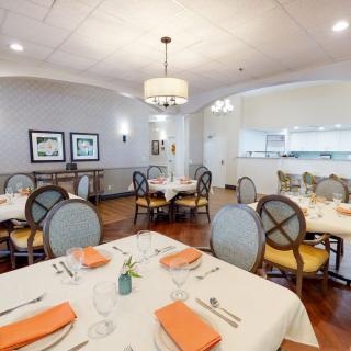 Elegant restaurant dining area with neatly set tables and warm lighting.