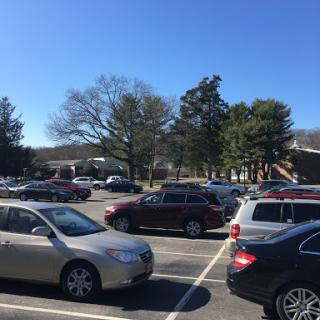 A view of a bustling parking lot on a clear day.