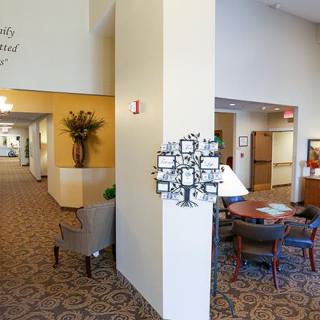 A welcoming lobby area with comfortable seating, decorative elements, and a carpeted hallway.