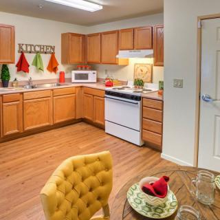 Cozy kitchen with wooden cabinets and a small dining area.