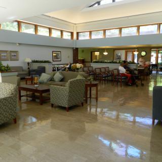 A spacious and modern lobby with comfortable seating and large windows.