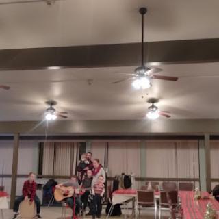 An evening of music and camaraderie as performers entertain the audience in a cozy setting.