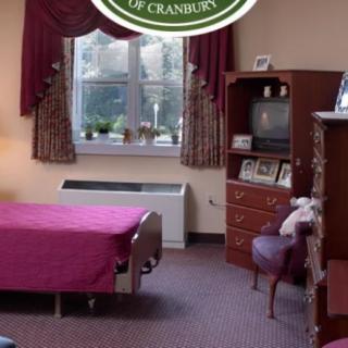 A cozy bedroom interior with traditional furniture and a television.