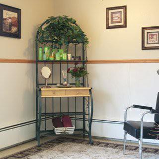 A cozy waiting room corner with a decorative shelf and chair.