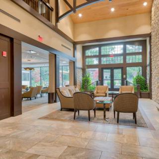 A modern and spacious lobby with comfortable seating and large windows.