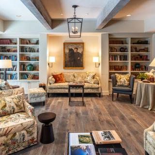 A cozy living room with comfortable seating, bookshelves, and stylish decor.