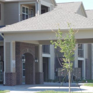 A modern apartment building with a covered entrance.