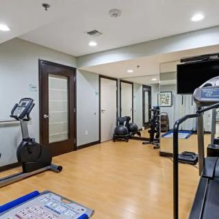 A well-equipped home gym with exercise machines and mirrors.