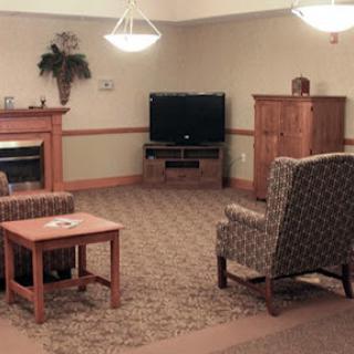 A cozy living room setup featuring comfortable seating, a television, and a warm ambiance.