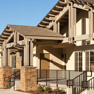 A modern building with wooden architectural elements and stone accents.