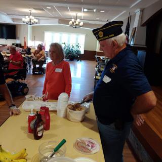 A community event where volunteers serve food to seniors.