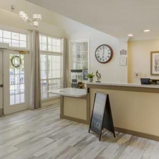 A modern office reception area with a welcoming desk and stylish decor.